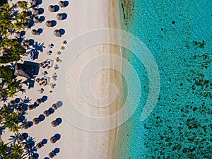 Le Morne beach Mauritius,Tropical beach with palm trees and white sand blue ocean and beach beds with umbrella,Sun