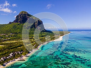 Le Morne beach Mauritius,Tropical beach with palm trees and white sand blue ocean and beach beds with umbrella,Sun