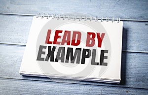 lead by example text on card, concept background