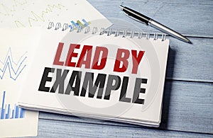 lead by example text on card, concept background