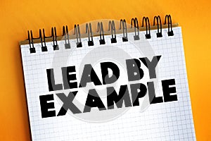 Lead By Example text on notepad, concept background