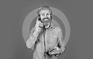 Lead generation specialist. Sales script. Bearded man phone conversation. Retro phone. Outdated technology. Manager