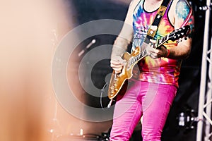 Lead guitarist in a rock or heavy metal band in a tie dyed vest