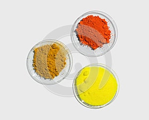 Lead II,IV oxide, Potassium Chromate and Organic Curcuma Powder in Chemical Watch Glass. Closeup chemical ingredient on white