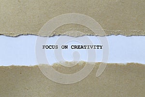 focus on creativity on white paper