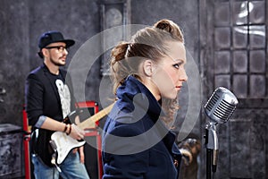 Lead singer stands at microphone