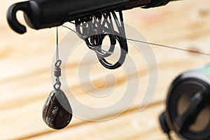 Lead sinker on wooden background macro shot