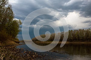 Leaden clouds gathered over the Ural river before sunset