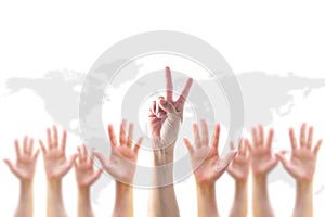 Leader`s two fingers V victory sign among blur hands crowd group for World participation, leadership, volunteer concept