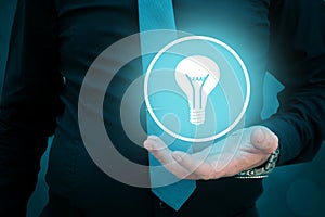 Leader think about business, creativity, business vision. Businessman holding light bulb in his hand