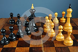 Leader vs boss or manager. Chess kings and pawns on desk