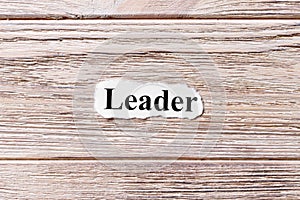 Leader of the word on paper. concept. Words of Leader on a wooden background