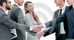 Leaders of business teams shake hands