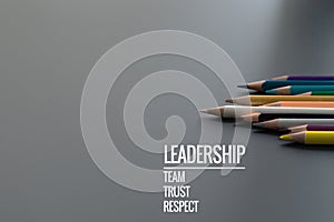 Leadership business concept. Gold color pencil lead other color with word Leadership, team, trust and respect on black background