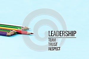 Leadership business concept. Gold color pencil lead other color with word Leadership, team, trust and respect on black background