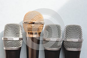 Leadership concept. group of microphones with golden one. freedom to speak up concept photo