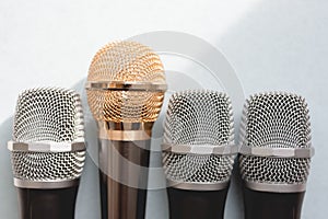 Leadership concept. group of microphones with golden one. freedom to speak up concept