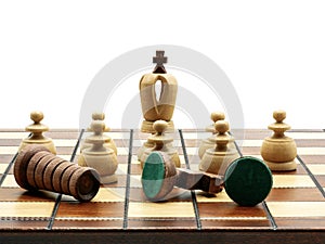 Leadership Concept: King Chess Piece With Pawns And Defeated Chess Pieces