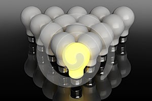 Leadership concept. One glowing light bulb standing in front of