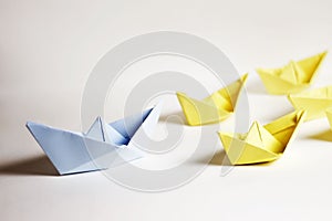 Leadership concept. Paper boats on a white background.