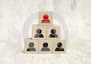 Leadership concept using red people icon cube among other cubes