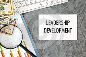 Leadership Development is written in a document on the office desk, money, diagram and keyboard