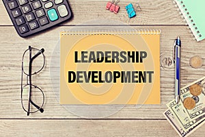 Leadership Development is written on a notepad on office desk