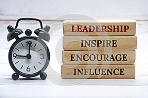 Leadership, inspire, encourage, influence text on wooden blocks with white cover background. Leadership concept.