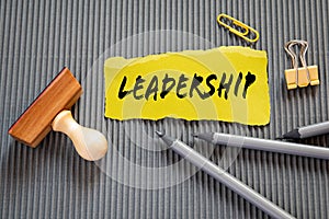 Leadership. Yellow sheet of paper with text on a gray background