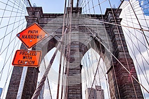 Leading Lines and orange signs on the Brooklyn Bridge photo