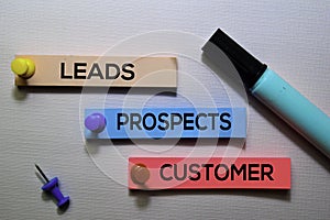 Leads, Prospects, Customer text on sticky notes isolated on office desk