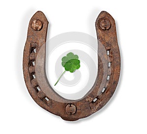 Horseshoe and a four-leaf clover with drawn leaf