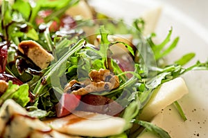 Leaf vegetable salad with cheese, grapes, walnuts and tasty sauce. Healthy, diet food