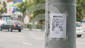 Leaflet about the missing child hanging on a pole