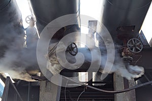 Leakage of steam in heat pipeline. Steam outgoing from the rusty tube with valve