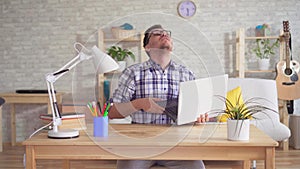 Leaking from the ceiling to a worried young man with a laptop sitting at a table