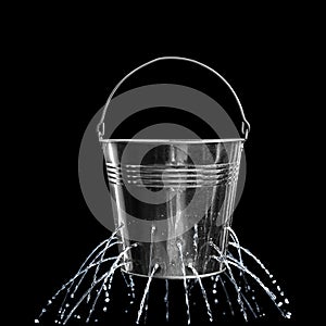 Leaky bucket with water on background photo