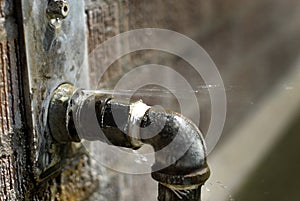 Leaky Pipe with Water Spraying Squirting Out photo