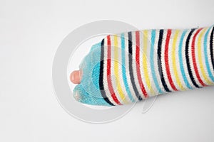 Leaky striped sock with visible finger of kid