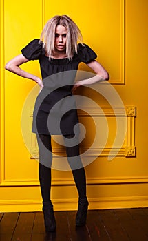 Lean girl posing on yellow background
