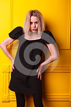 Lean girl posing on yellow background