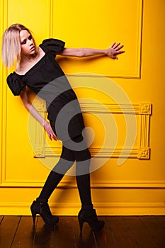 Lean girl posing on yellow background