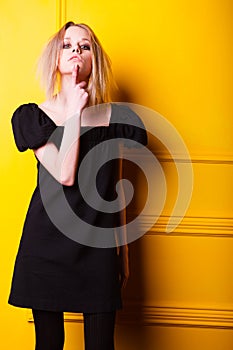 Lean girl posing on yellow background