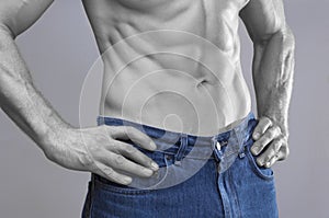 Lean male abs in blue jeans