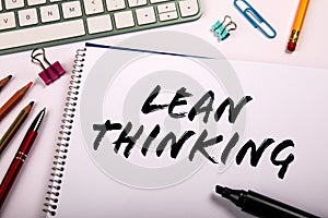 Lean Thinking. Note paper with text and computer keyboard on office table