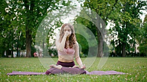 Lean Woman practices Breathing on Mat. Yoga Inhaling and Exhaling Exercise