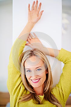 Leaning against a wall, portrait and home with woman, relax and resting with comfort and confidence. Face, person and