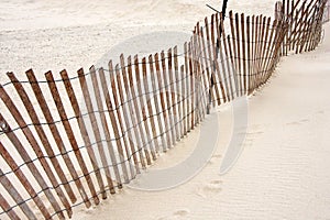 Leaning beach fence on sand