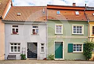 Leaning roofs on a renovated semi detached house with historic windows and doors in the old town of Wismar