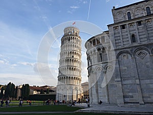 The leaning tower of Pisa and Piazza dei Miracoli in a sunny day - The Miracle Square, the Leaning Tower and the Cathedral is